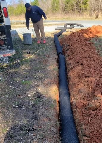 We dug trenches out to install our EZflow drainage that would send the water away from the home.