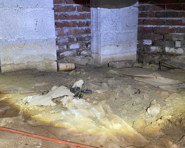 The crawl space of this home was littered with old construction materials, trash and an old vapor barrier system that had broken down.