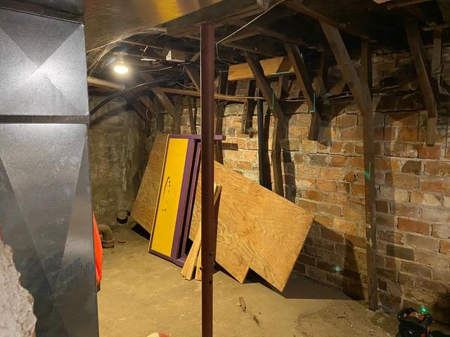 Room with wall that is need of repair.