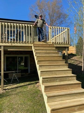 Mr standing at the top of the new stairs for the deck