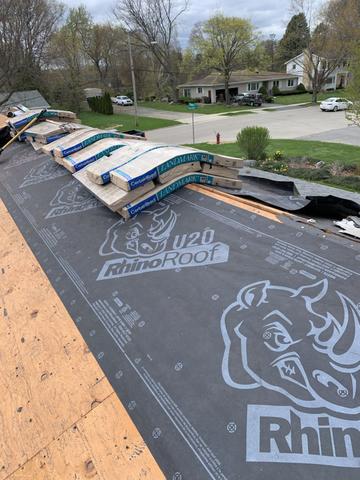 RhinoRoof underlayment was installed to protect the decking (boards). The shingles were lifted onto the roof by our supplier.