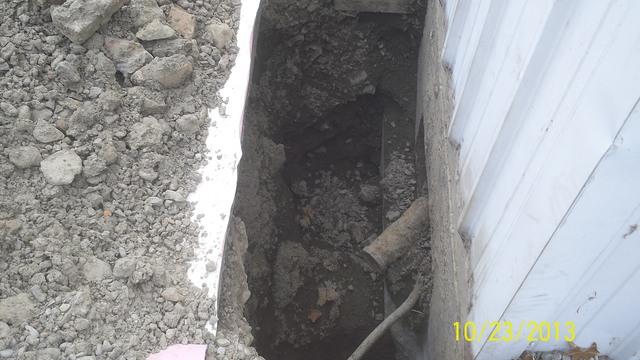 The first step to installing a Push Pier systems is to dig down to the foundation footing.