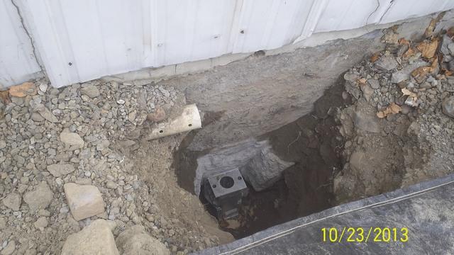 A heavy duty steel foundation bracket is then secured to the footing.