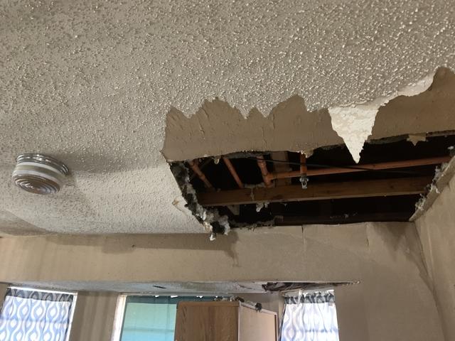 This shows the water damaged ceiling where the pipes burst.