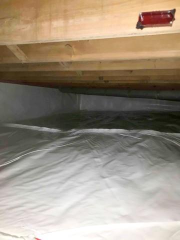 CleanSpace vapor barrier installed for a complete crawl space encapsulation to prevent moisture from passing through the ground and walls