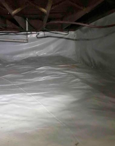 CleanSpace vapor barrier installed for a complete crawl space encapsulation to prevent moisture from passing through the ground and walls