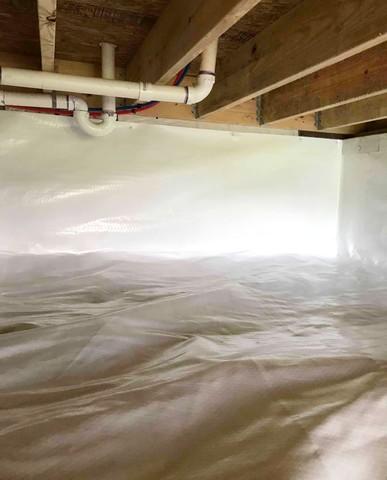 CleanSpace vapor barrier installed for a complete crawl space encapsulation to prevent moisture from passing through the ground and walls