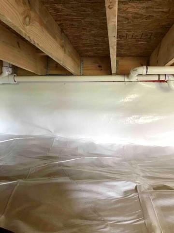 CleanSpace vapor barrier installed for a complete crawl space encapsulation to prevent moisture from passing through the ground and walls