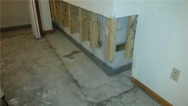 One of the walls of the basement with the WaterGuard XL installed at the bottom