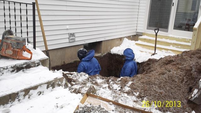 First step to installing the Rockwell Egress window system is to dig a hole around the existing window deep enough for the window well.