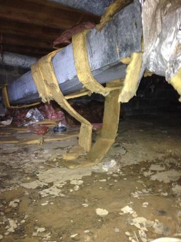 <p>Where to begin? The ducts in this crawlspace were poorly-installed and uninsulated, losing conditioned air into the damp crawl. The crawl itself had a dirt floor, which allowed moisture to wick up, creating an uncomfortable and ultimately hazardous situation. Mold had formed on the walls and floor joists, a major health and safety concern.</p>