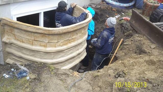 The RockWell is put into place and secured to the foundation wall