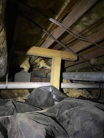 There were wooden support posts in the crawlspace in some areas, but wooden posts are susceptible to sinking and settling over time.