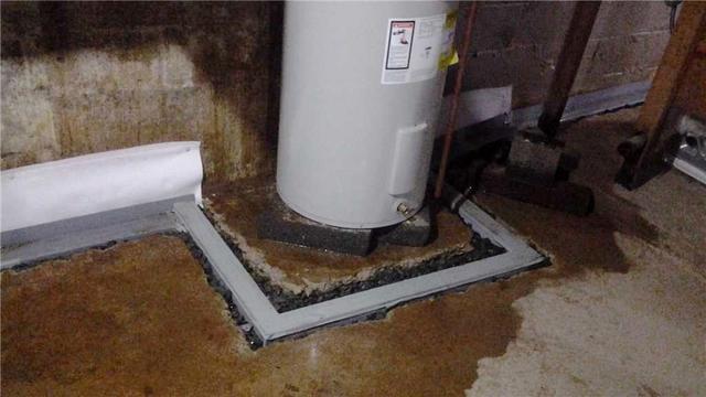 <p>The waterproofing system is installed around the water heater. Together, the WaterGuard Drainage System and TrenchDrains will keep the basement dry.</p>