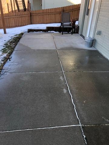 The back patio was sinking in areas causing it to slope in different directions.