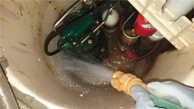 The sump pump vacuum is being used to thoroughly clean out the sump pump system.