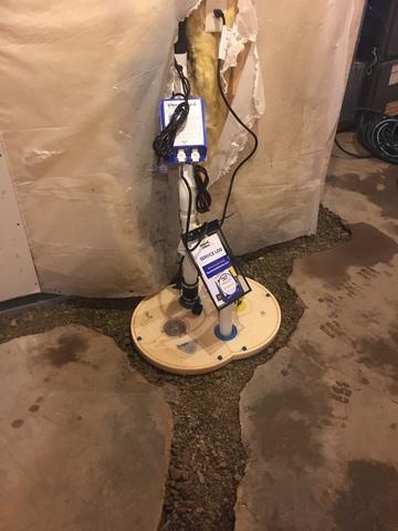 Our crew installed our WaterGuard and TripleSafe Sump Pump then added rock and pea gravel in the broken-out gaps in the floor.