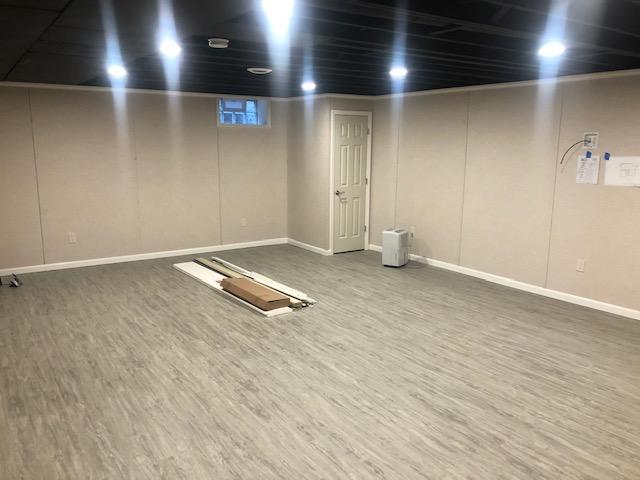 <p>Our EverLast Wall Panels, and grey Thermal Dry Elite Plank Flooring are perfectly complemented by the white trim, 6-panel doors, and the painted ceiling with convenient recessed lighting. We hope that the homeowners and their families can enjoy this basement for years to come!</p>