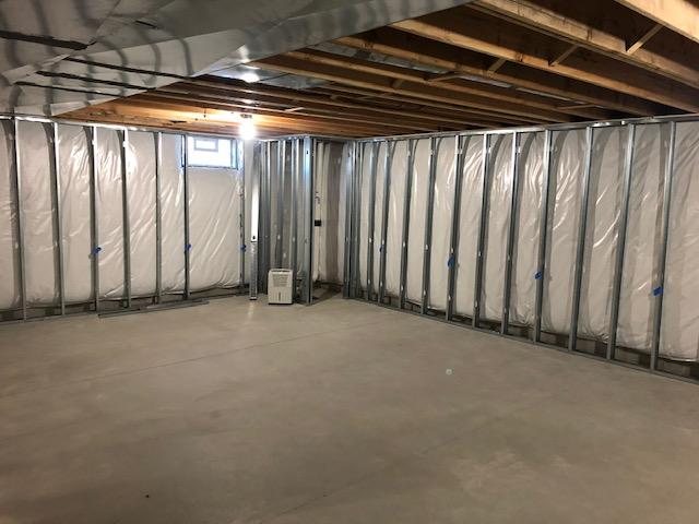 <p>Early in the installation process, you can see the framework for the EverLast Wall Panels has been installed around the exterior of the finished area of the basement as well as to divide the basement into finished and unfinished halves.</p>