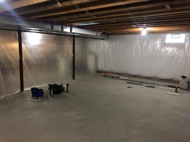 <p>Early in the installation process, the basement is being prepped for the framework for the EverLast Wall Panels that will be installed around the exterior of the finished area of the basement as well as to divide the basement into finished and unfinished halves.</p>