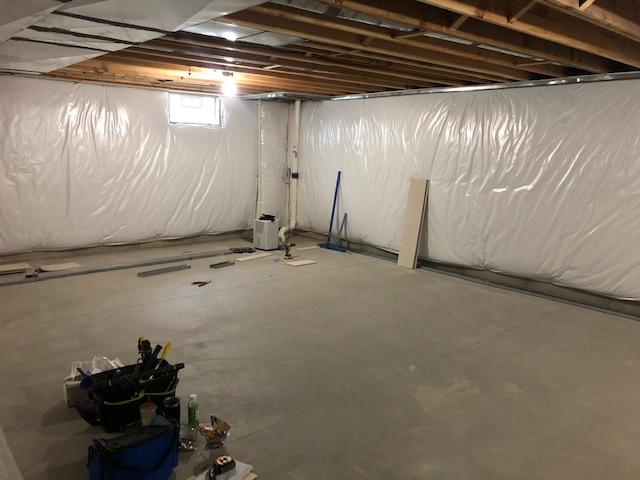 <p>Early in the installation process, the basement is being prepped for the framework for the EverLast Wall Panels that will be installed around the exterior of the finished area of the basement as well as to divide the basement into finished and unfinished halves.</p>