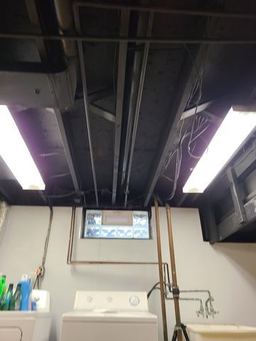 <p>The basement ceiling has been painted black and the lights reinstalled. Even though it is dark it looks clean and adds depth to the space.</p>