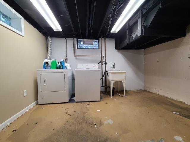 The basement ceiling has been painted black and the lights reinstalled. Even though it is dark it looks clean and adds depth to the space.