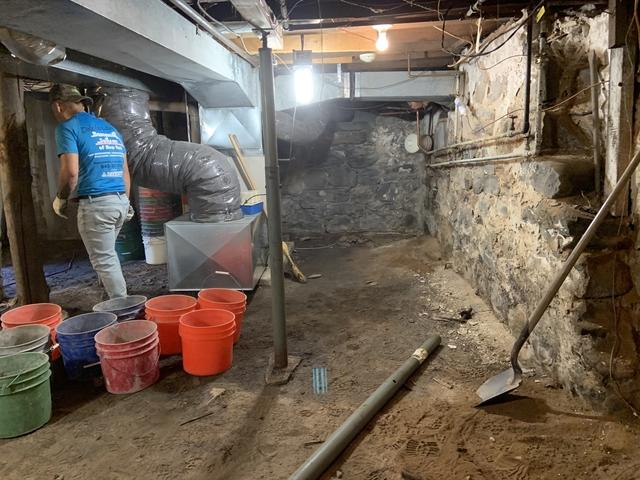 How things looked before we started digging their dirt floor down on the right hand side as well as the back center of their basement.