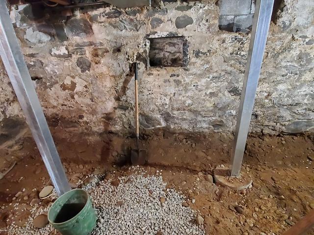 Fully installed SmartJacks on pre-cast footings on the right side of the basement.