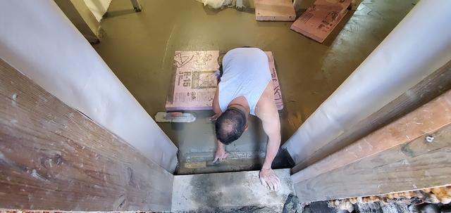 Putting the final finish on the edge of our new slab before letting it dry.