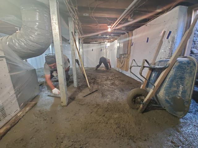 After laying our concrete in this basement we started to distribute it evenly throughout the entirety of the basement.