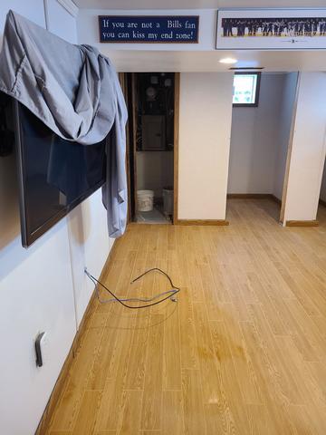 <p>The basement is 95% finished, an electrician was coming in the next day to finish wiring the new outlets, and the man cave was done! The EverLast Wall Panels and Thermal Dry Elite Plank Flooring look fantastic in this basement and give it a warm and inviting look.</p>