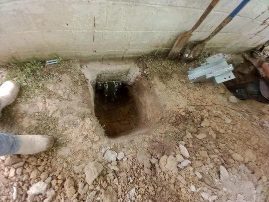 Our BSWV crews installed nin hydraulically-driven Push Piers under the garage in order to stabilize the settling area.