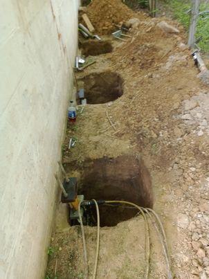 Our BSWV crews installed nin hydraulically-driven Push Piers under the garage in order to stabilize the settling area.