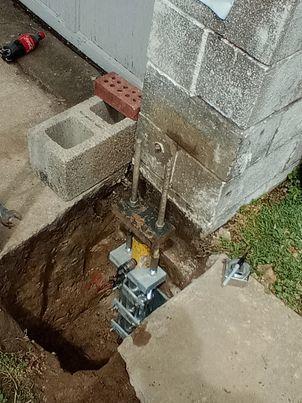 Our BSWV crews installed nin hydraulically-driven Push Piers under the garage in order to stabilize the settling area.