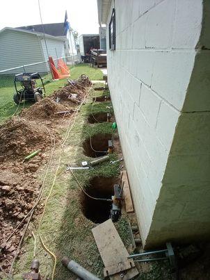 Our BSWV crews installed nin hydraulically-driven Push Piers under the garage in order to stabilize the settling area.
