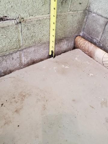 Upon the initial inspection, our Design Specialist measured 3 inches of settlement in this corner of the garage. Soil washout is the main culprit of sinking and settling concrete.