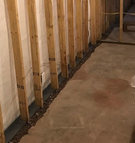 Our team installed our WaterGuard Below Floor Drain and CleanSpace Wall System Vapor Barrier to fully waterproof the basement.