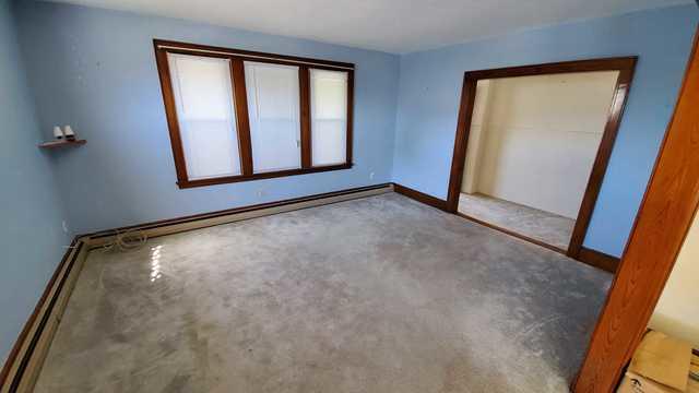 An empty living room after removal of the furniture