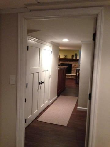 This hallway connects the living space to the bedroom suite, but the family took full advantage of the space by adding these great storage cabinets. You can also see their beautiful fireplace peeking around the corner!