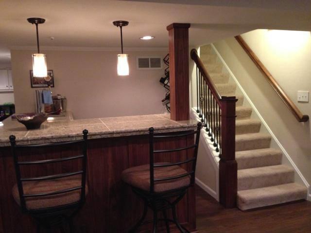 A full bar with trendy finishes makes this basement the perfect entertainment space for date nights or just having friends over.