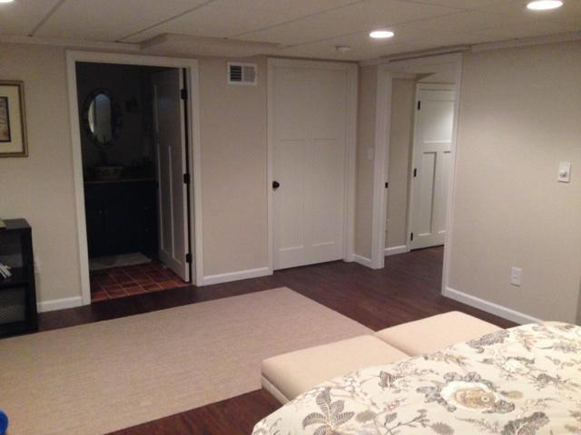 This is the view from the bed, which shows how spacious the room is, as well as the door to the bathroom and hallway. What a spacious, beautiful basement!