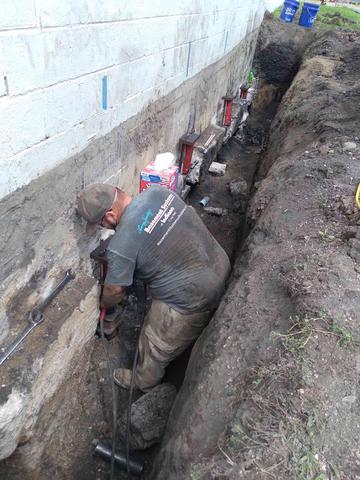 Crew Installing Push Piers