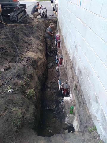 Crew Installing Push Piers