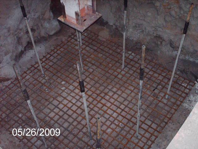 <p>This is a picture of micropiles extending through a rebar mat</p>