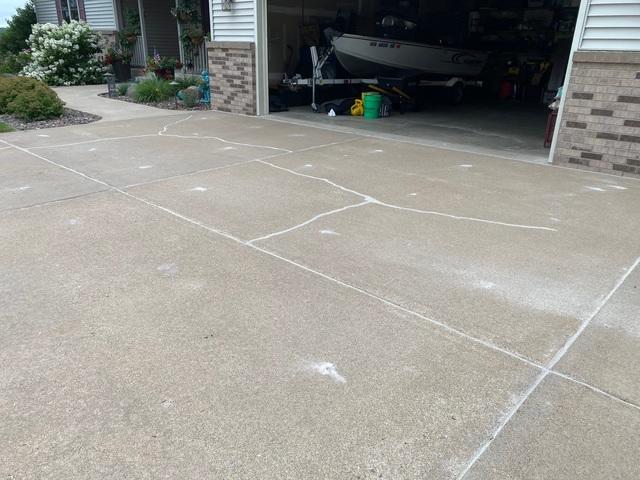 After raising the driveway, our concrete crew carefully applied our NexusPro™ Joint Sealant.