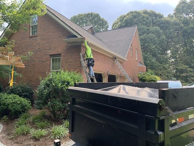 Installing the new gutter system. This color is wicker