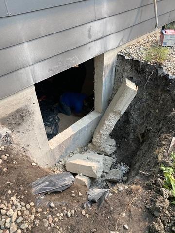 Our team excavated the soil surrounding the window, broke out the old window for the new one, and hauled away the rock and bricks.