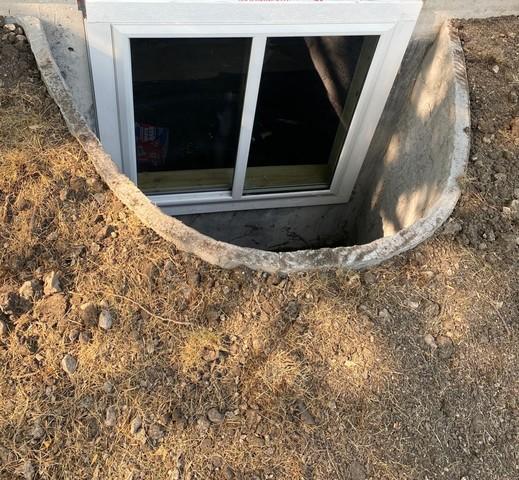 Our crew completed the installation by installing the window and our RockWell Window Well, and compacting the soil, ensuring the space was cleaner than how they found it.