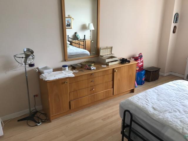 Master bedroom ready for decluttering in an apartment in Kingsbridge, Bronx, NY.